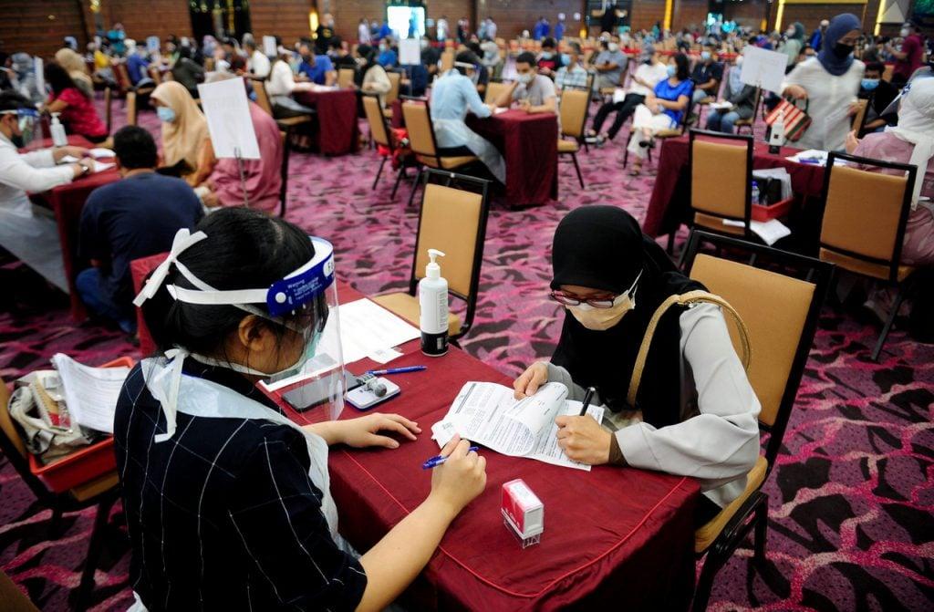 People register at the Ideal Convention Centre in Shah Alam to receive their first dose of the AstraZeneca Covid-19 vaccine in this May file picture. Photo: Bernama