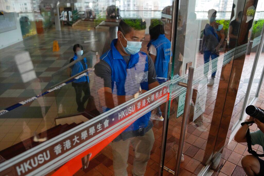 Police officers set up a cordon line at the office of student union in campus of the University of Hong Kong, July 16. Photo: AP