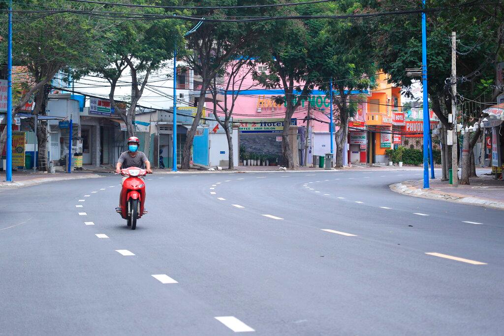 A man rides a scooter on a quiet street in Vung Tau, Vietnam, July 18. Vietnam has put its entire southern region in a two-week lockdown as confirmed daily Covid-19 cases exceeded 3,000 for the third day in a row. Photo: AP