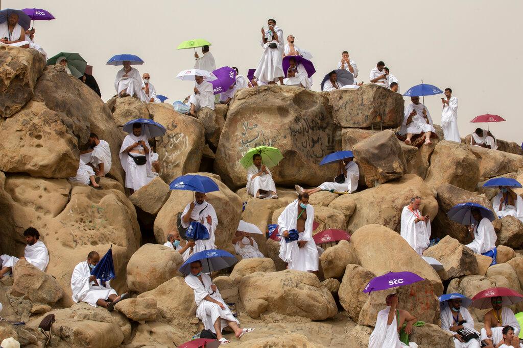 Muslim pilgrims pray on top of the rocky hill known as the Mountain of Mercy, on the Plain of Arafat, beside inscriptions which were left by pilgrims from previous years, during the annual haj pilgrimage near the holy city of Mecca, Saudi Arabia, July 19. Photo: AP