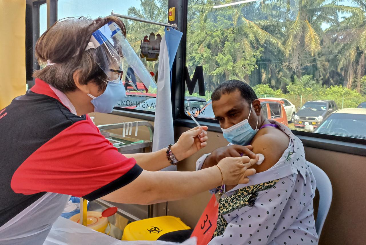 A volunteer nurse administers a shot of Covid-19 vaccine under the Community Vaccine Mobilisation Programme in Machap Jaya, Alor Gajah. Photo: Bernama