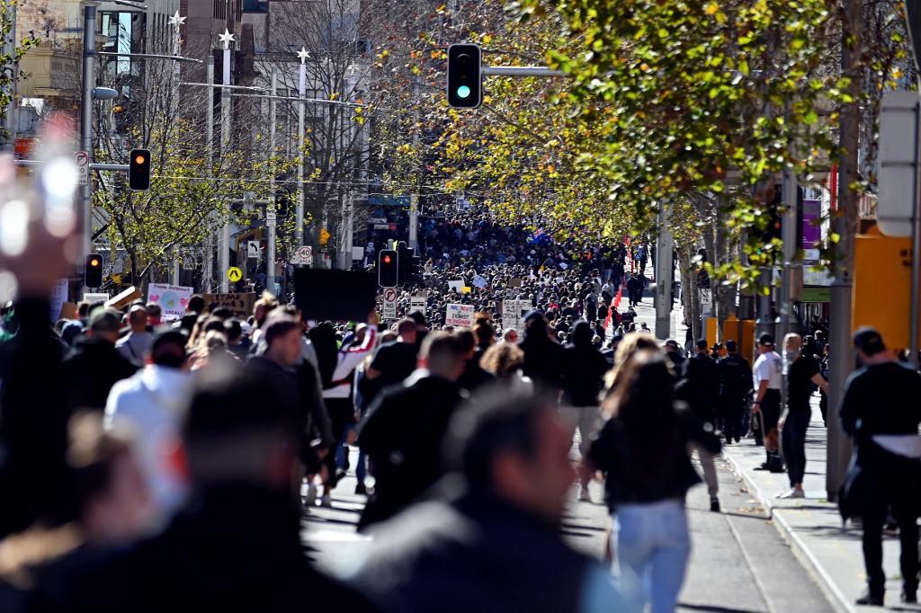 Protesters march along a street in Sydney on July 24, as thousands of people gathered to demonstrate against the city's month-long stay-at-home orders. Photo: AFP