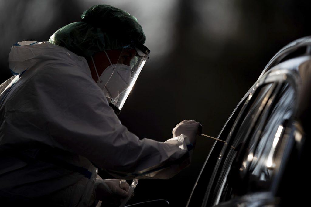 An employee takes a smear sample for a Covid-19 test from a driver at a drive-in test centre in Nuertingen, Germany. Photo: AP