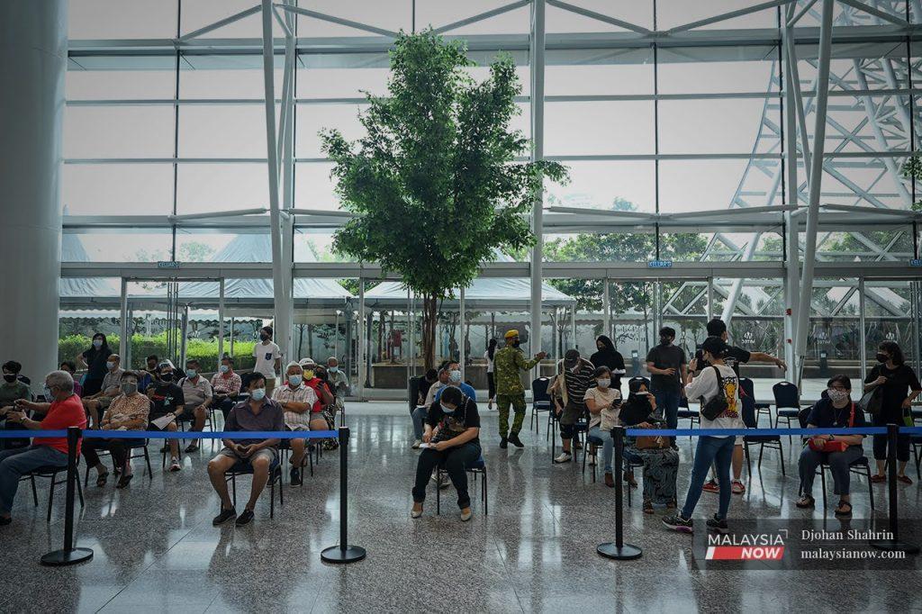 People register to receive Covid-19 jabs at the Mitec vaccination centre in Jalan Dutamas, Kuala Lumpur.