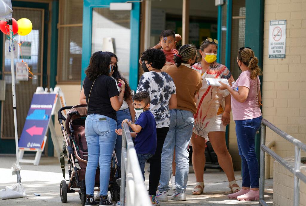 Families gather at a vaccination centre in Los Angeles after receiving their jabs, July 22. Photo: AP