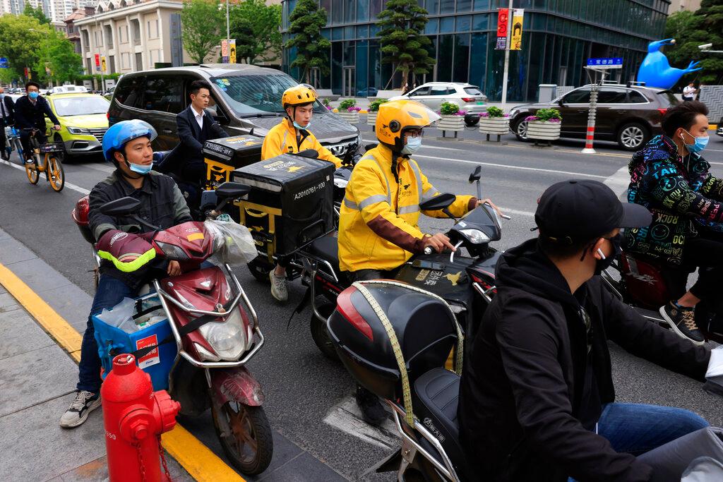Meituan food delivery riders in yellow on the streets of Shanghai, China, April 21. Photo: AP