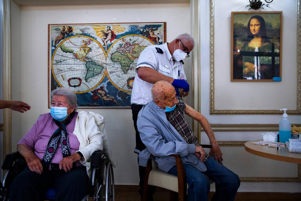 A man receives his second Pfizer-BioNTech Covid-19 vaccine at a private nursing home in Ramat Gan, Israel, in this Jan 13 file photo. The country will soon begin offering booster shots to people over 60 who have already been vaccinated, making Israel the first country to offer a third dose of a Western vaccine to its citizens on a wide scale. PhotoL AP