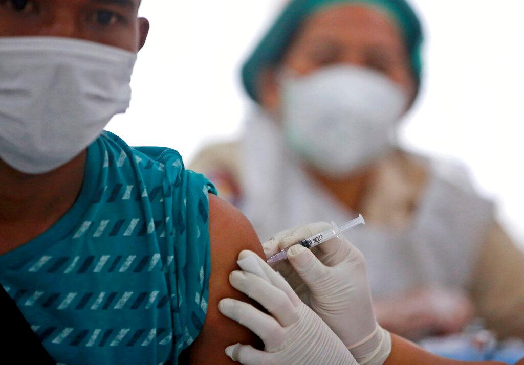 A man receives a shot of the Sinovac Covid-19 vaccine during a mass vaccination at Putri Hijau Military Hospital in Medan, North Sumatra, Indonesia, June 18. Photo: AP