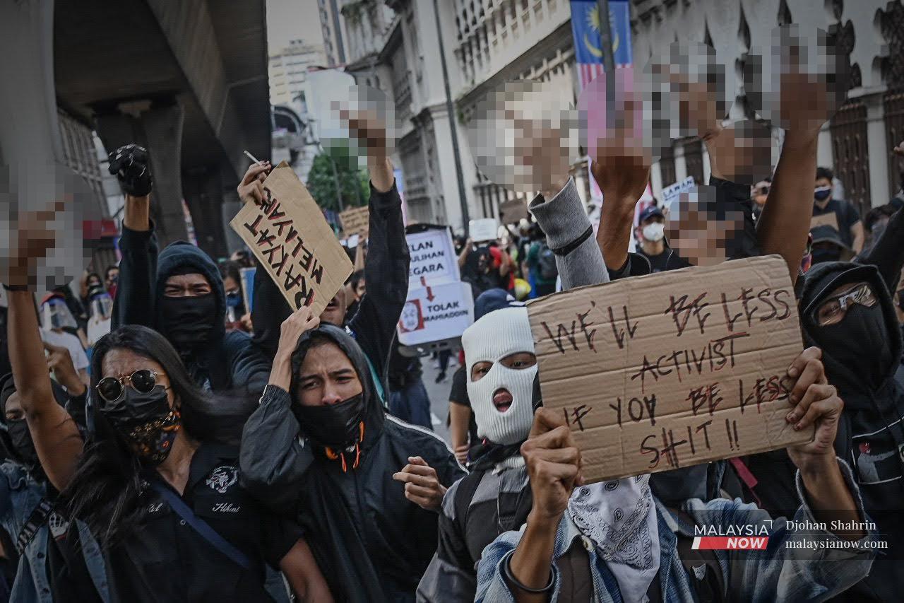 Several participants show the middle finger as the participate in the Lawan protest in Kuala Lumpur yesterday accusing the government of failing to contain the pandemic.