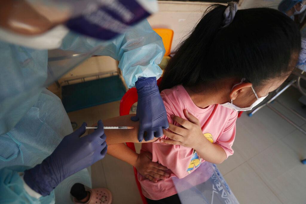 A nurse gives a shot of Sinovac's Covid-19 vaccine to a young girl at the Phnom Penh Thmey Health Center in Phnom Penh, Cambodia, Aug 1. Photo: AP