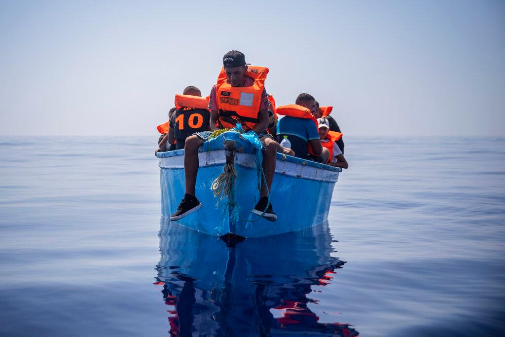 A group thought to be migrants from Tunisia aboard a precarious wooden boat waiting to be assisted by a team of the Spanish NGO Open Arms, around 20 miles southwest from the Italian island of Lampedusa, July 29. Migrant boat departures from Libya and Tunisia to Italy and other parts of Europe have increased in recent months as weather conditions have improved. Photo: AP