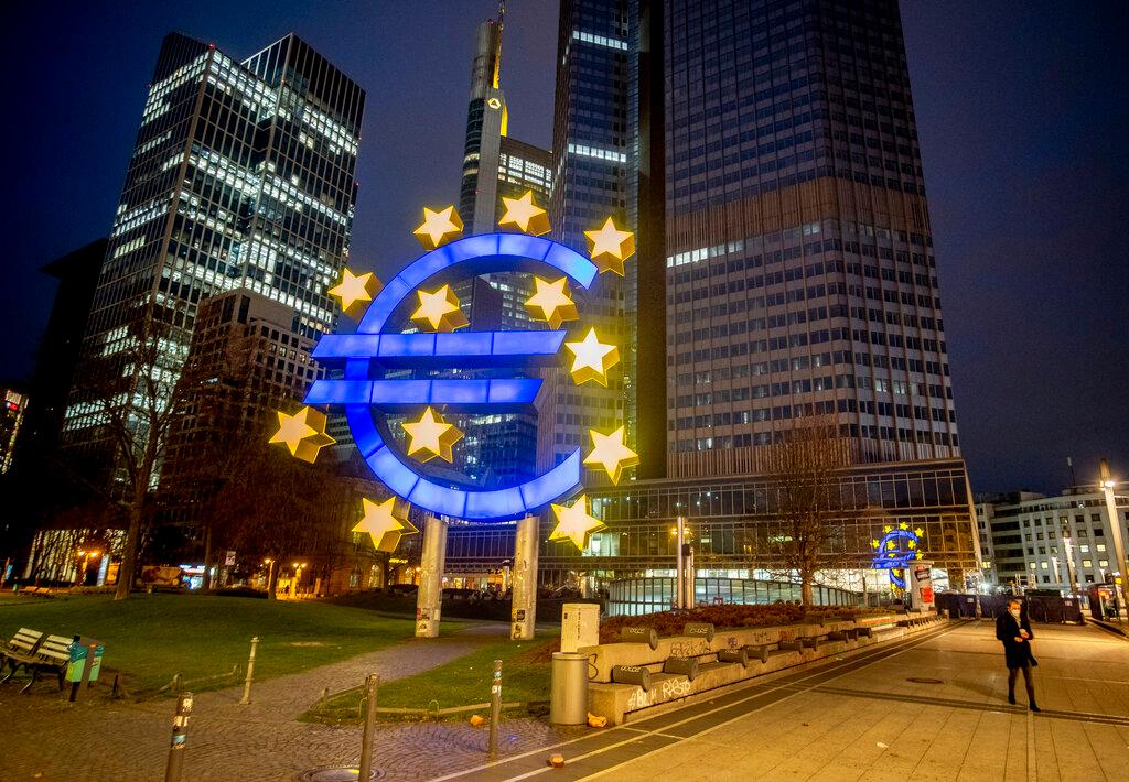 In this March 11 file photo, a man walks past the Euro sculpture in Frankfurt, Germany. Europe’s economy has rebounded into growth in the second quarter. Photo: AP