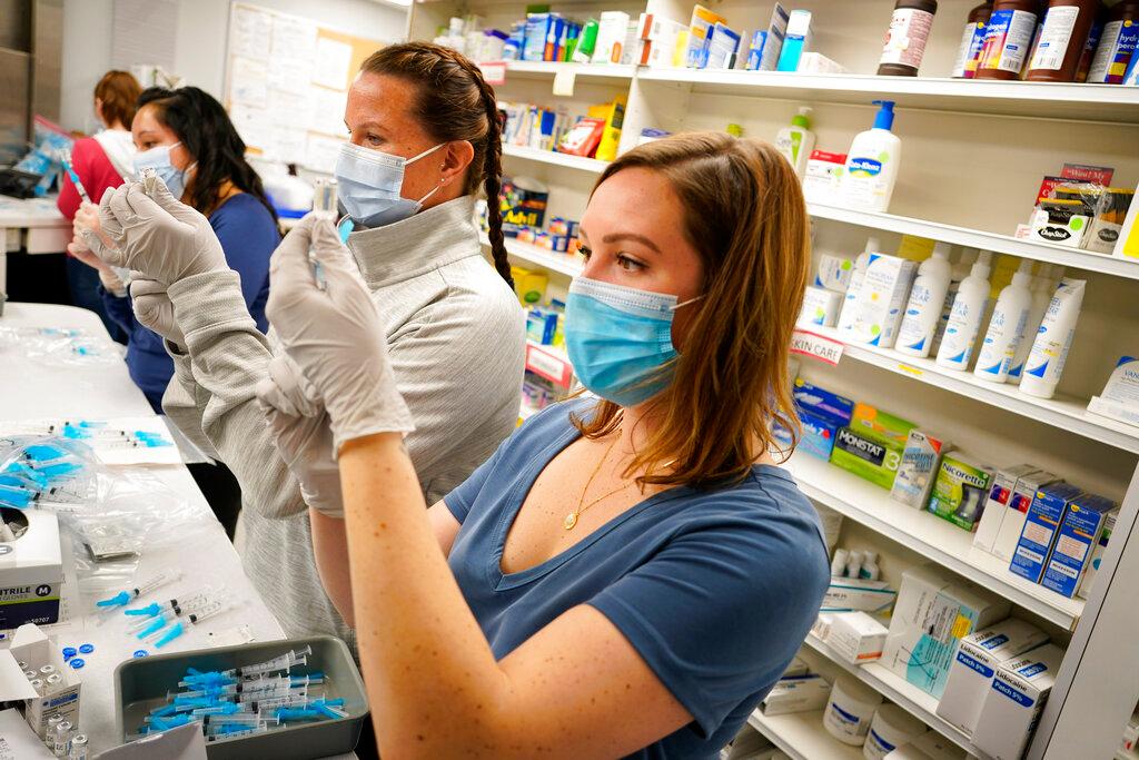 Nurses and pharmacists draw shots of the Johnson & Johnson Covid-19 vaccine at the pharmacy of National Jewish Hospital for distribution in east Denver in this March 6 file photo. Photo: AP