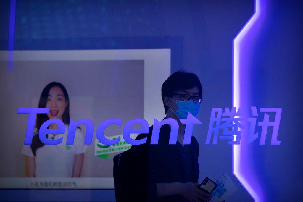 A visitor wearing a face mask walks past a logo for Chinese technology firm Tencent at its display at the China International Fair for Trade in Services in Beijing, in this Sept 5, 2020 file photo. Photo: AP