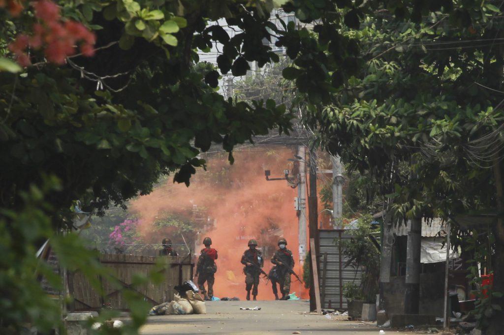 Soldiers walk towards anti-coup protesters during a demonstration in Yangon, Myanmar, March 30. Myanmar has been in turmoil since the army ousted the civilian leadership on Feb 1. Photo: AP