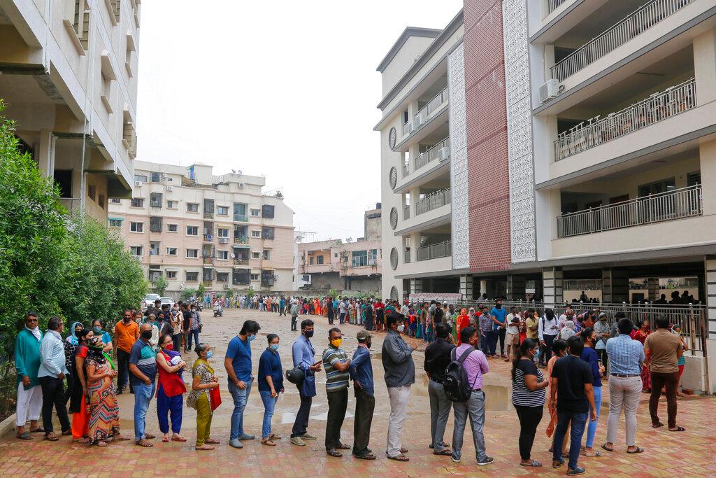 People stand in queue to get inoculated against Covid—19 at a vaccination centre in Ahmedabad, India, July 30. Photo: AP