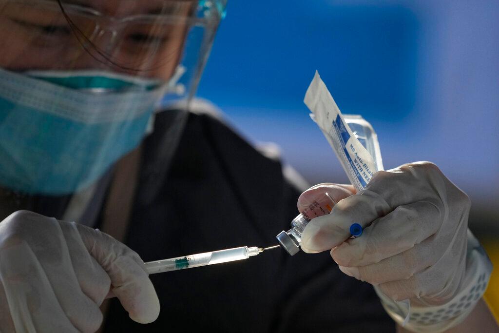 A health worker prepares China's Sinovac Covid-19 vaccine at a temporary vaccination centre in Manila, Philippines, June 22. Photo: AP
