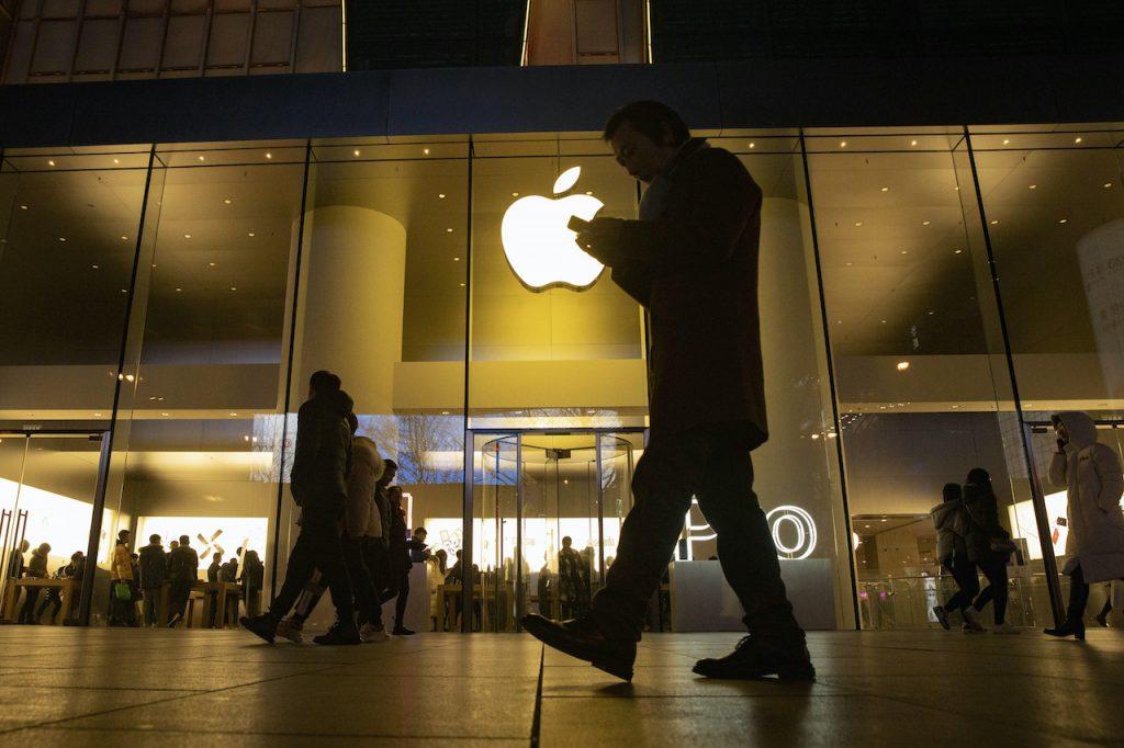 A man looks at his phone as he walks past a store of US tech giant Apple in a retail district in Beijing, in this Dec 13, 2019 file photo. Photo: AP