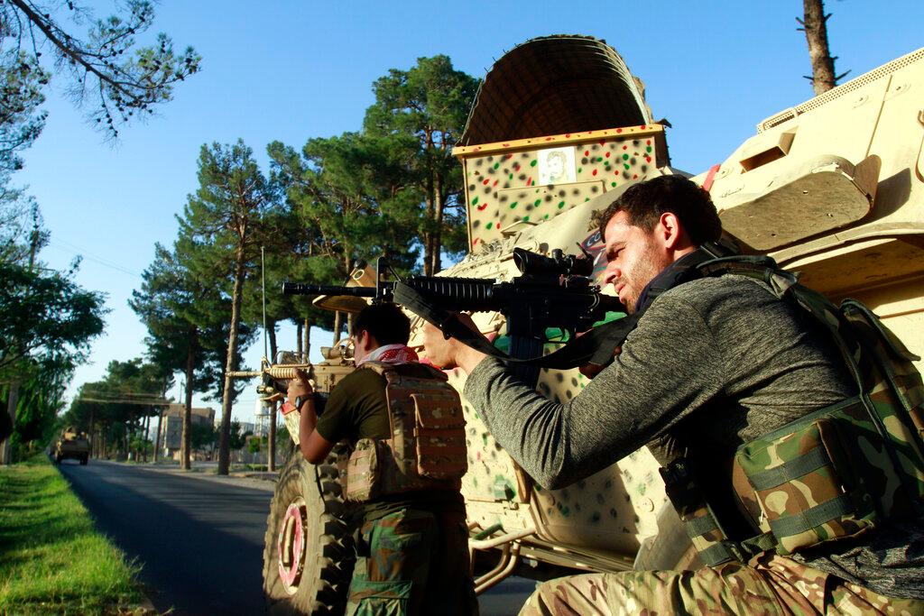 Afghan security personnel take position during fighting between Taliban and Afghan security forces in Herat province, west of Kabul, Afghanistan, Aug 3. The Taliban already control large portions of the countryside, and are now challenging Afghan government forces in several large cities. Photo: AP