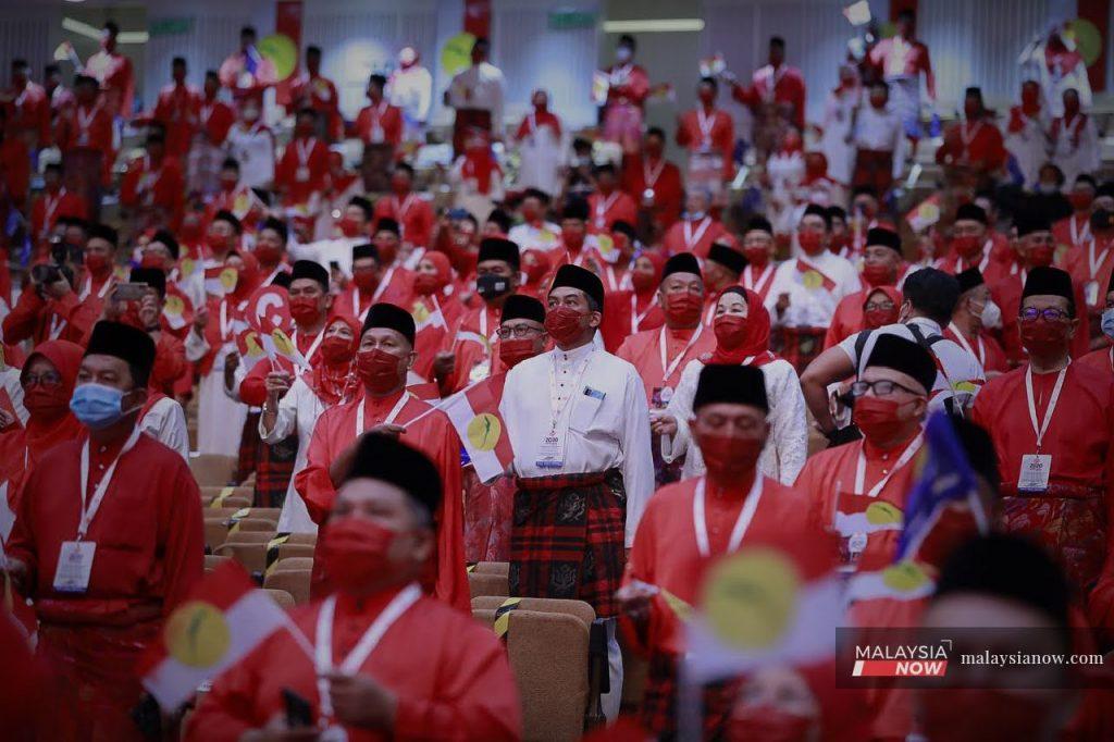 Delegates stand at the Umno general assembly in Kuala Lumpur in March. The Registrar of Societies yesterday ruled against Umno's postponement of its party polls by 18 months.