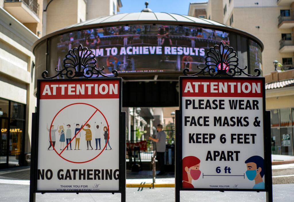 In this June 11 file photo, signs with social distancing guidelines and face mask requirements are posted at an outdoor mall amid the Covid-19 pandemic in Los Angeles. Photo: AP