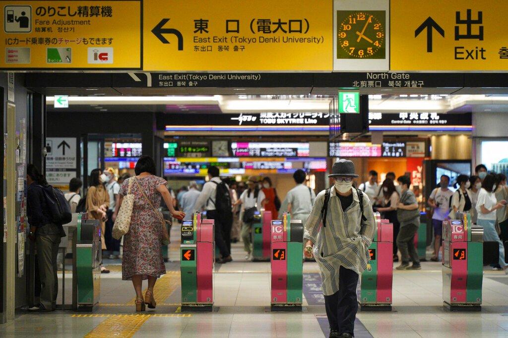 Passengers pass through the gates of a subway station in Tokyo, Aug 6. A man stabbed 10 passengers with a knife on a Tokyo subway on Friday and was arrested by police after fleeing, news reports say. Photo: AP
