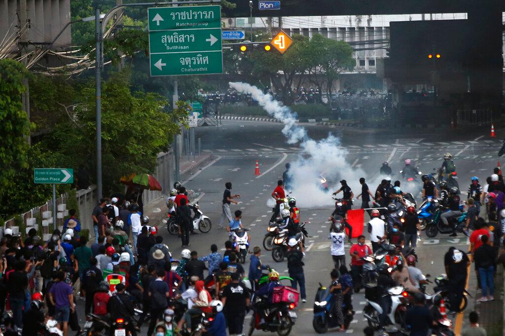Riot police launch tear gas at anti-government protesters during a protest in Bangkok, Thailand, Aug 7. Photo: AP
