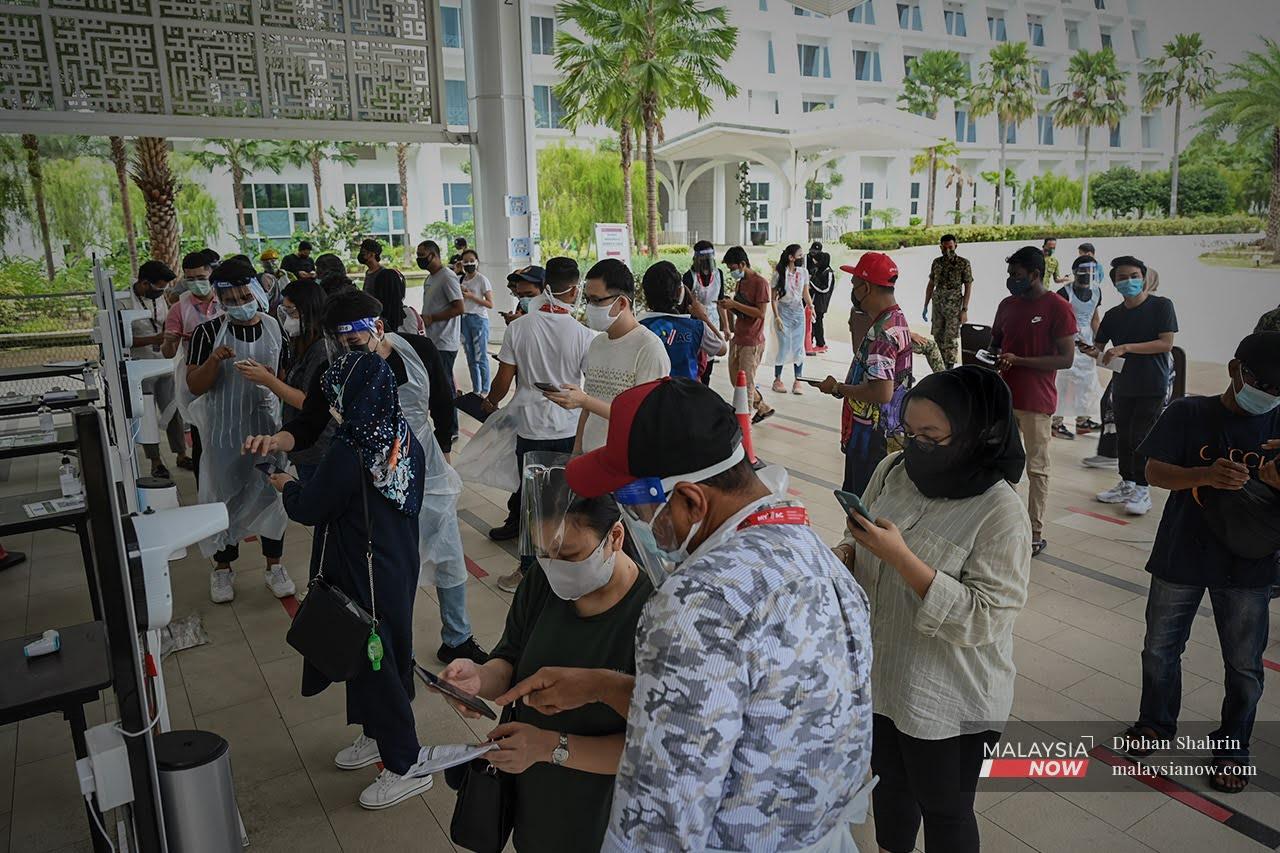 Walk-in vaccine recipients register for vaccination at the Movenpick centre in Sepang, Selangor.