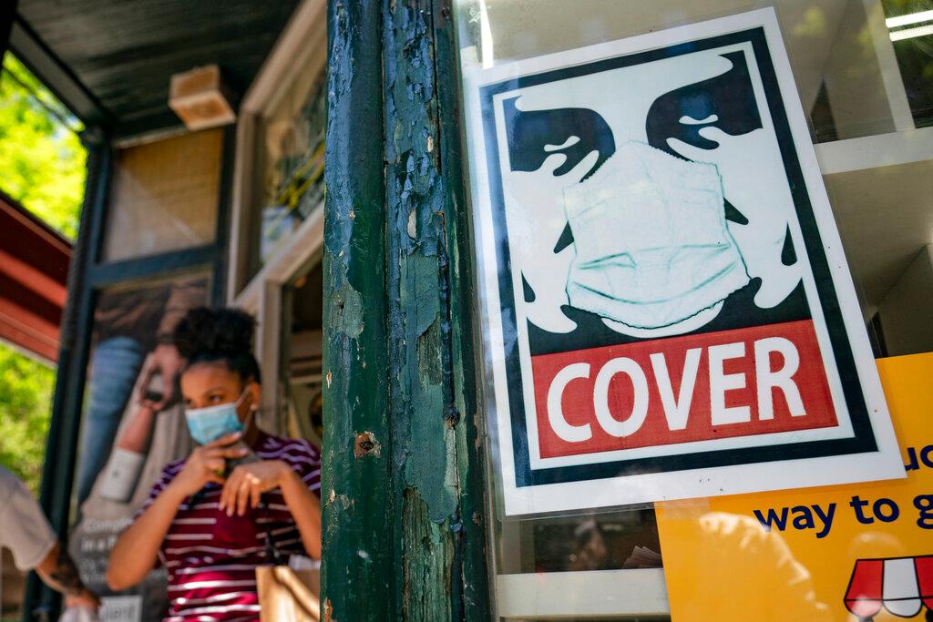 A customer exits a corner market while wearing a protective mask in the retail shopping district of the SoHo neighbourhood of the Manhattan borough of New York in this May 14 file photo. Photo: AP