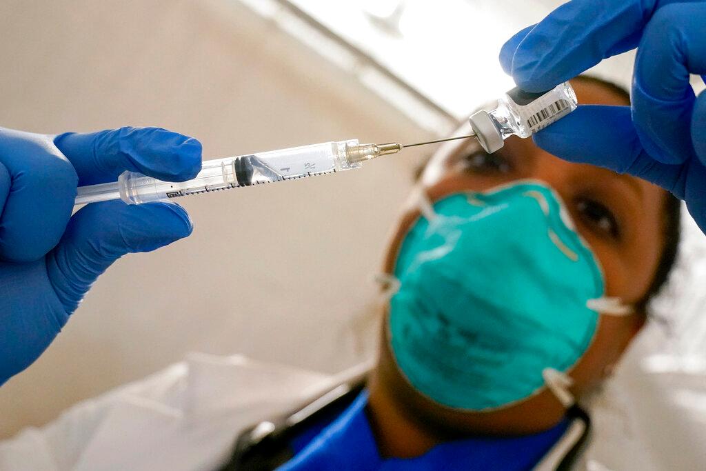 A doctor fills a syringe with the Pfizer Covid-19 vaccine at a vaccination centre in the East Harlem neighbourhood of New York in this Jan 15 file photo. Photo: AP