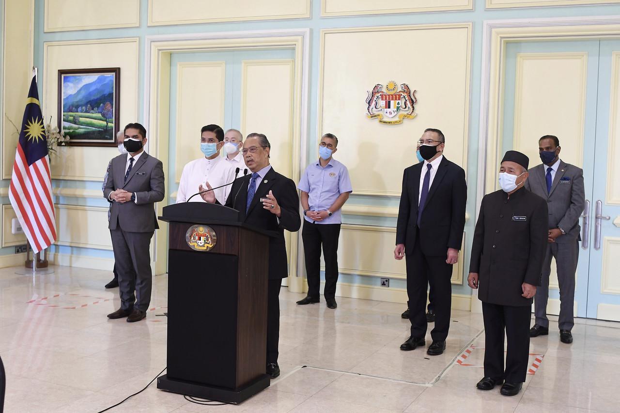 Prime Minister Muhyiddin Yassin, flanked by his Cabinet members, speaks at a special address today. Photo: Bernama