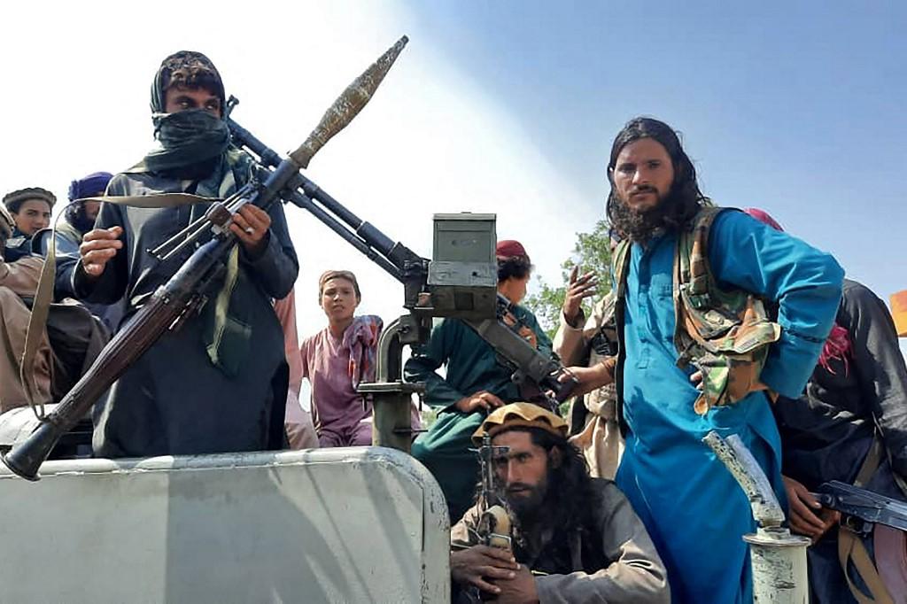 Taliban fighters sit over a vehicle on a street in Laghman province on Aug 15. The scale and speed of their advance have shocked Afghans and the US-led alliance that poured billions into the country after toppling the insurgents in the wake of the Sept 11, 2001 attacks. Photo: AFP
