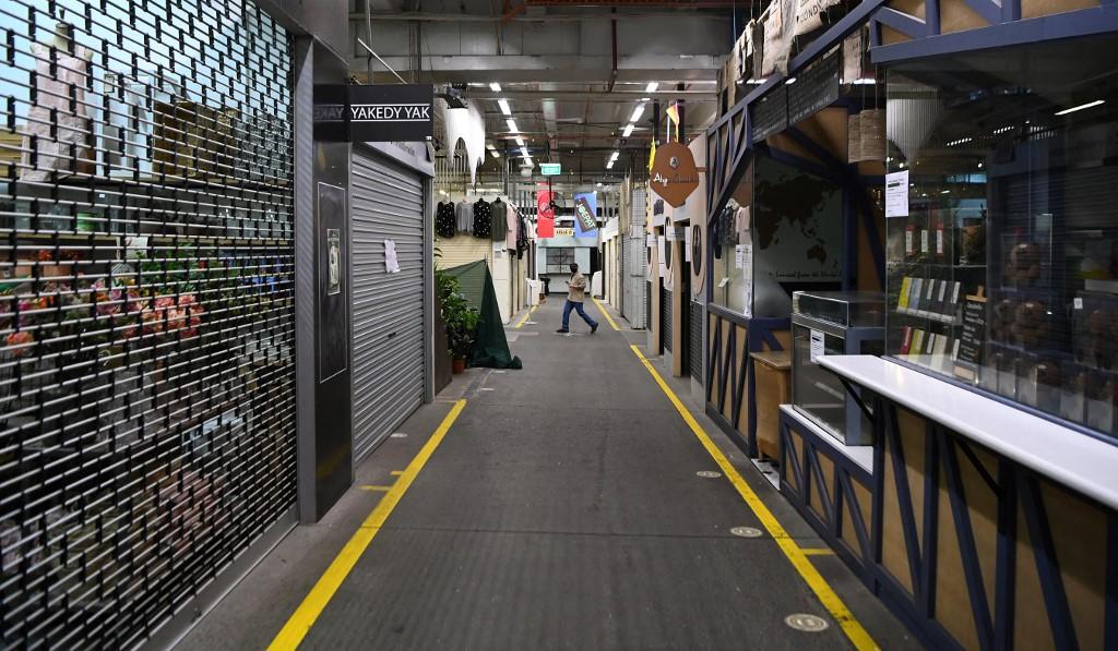 A man walks through a near-deserted market in Melbourne on Aug 13 as the city continues to endure its sixth lockdown. Photo: AFP