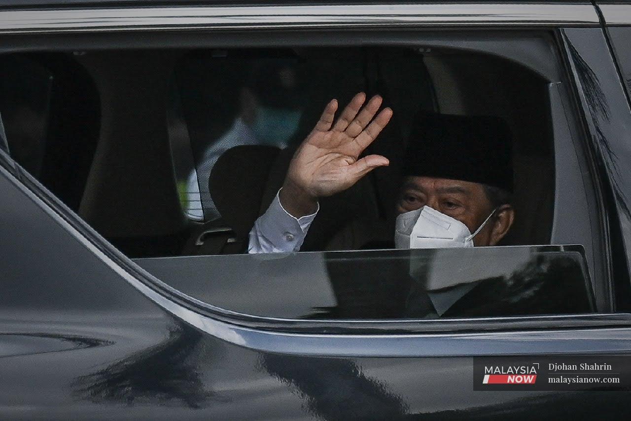 Muhyiddin Yassin waves on his arrival at Istana Negara for his audience with the Yang di-Pertuan Agong yesterday.