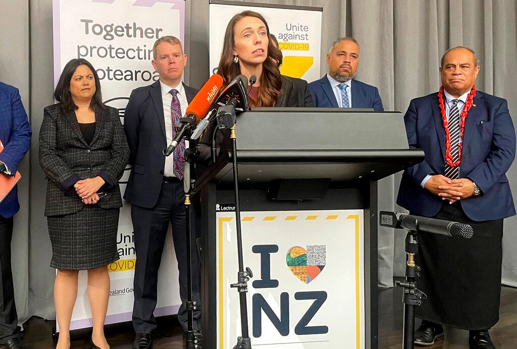 Flanked by lawmakers, New Zealand Prime Minister Jacinda Ardern delivers a speech on Aug 12 in Wellington, New Zealand. Photo: AP