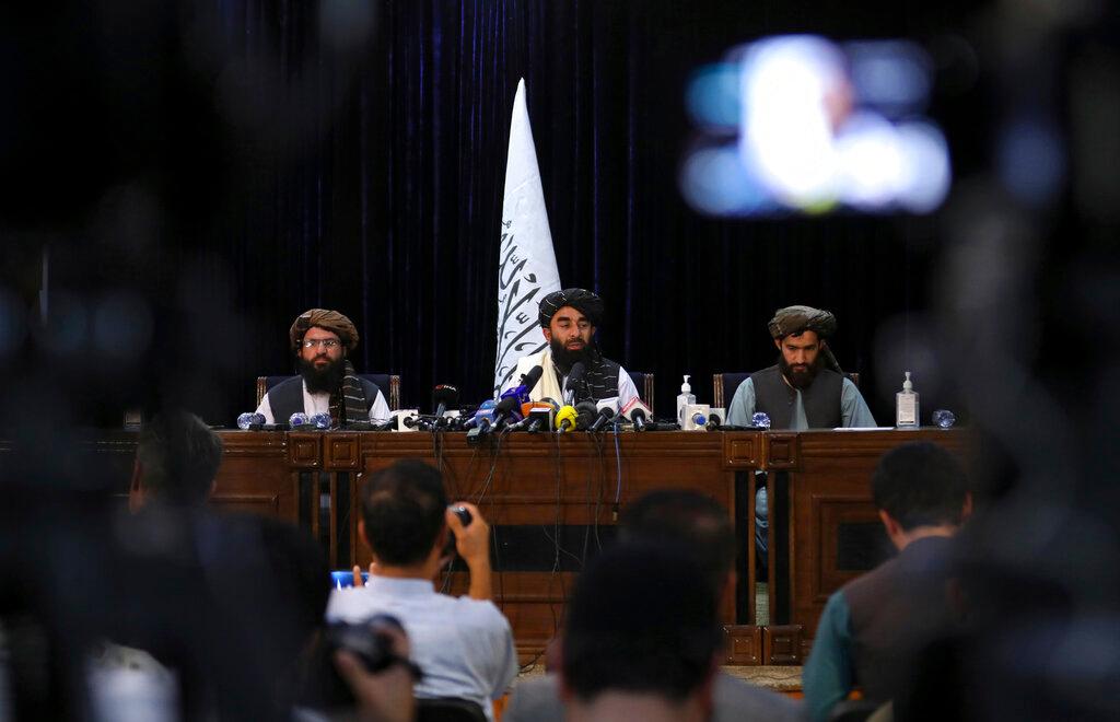 Taliban spokesman Zabihullah Mujahid (centre) speaks at his first news conference in Kabul, Afghanistan, Aug 17. Photo: AP