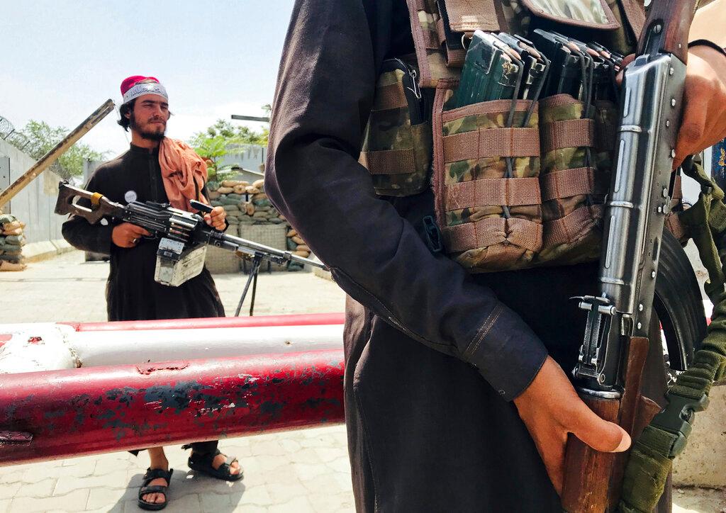 Taliban fighters stand guard at a checkpoint near the US embassy that was previously manned by American troops, in Kabul, Afghanistan, Aug 17. Photo: AP