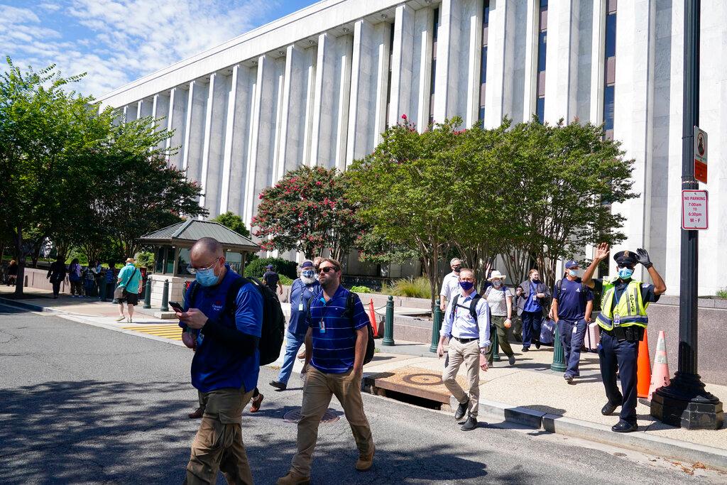 People are evacuated from the James Madison Memorial Building, a Library of Congress building, in Washington on Aug 19, as law enforcement investigate a report of a pickup truck containing an explosive device near the US Capitol. Photo: AP