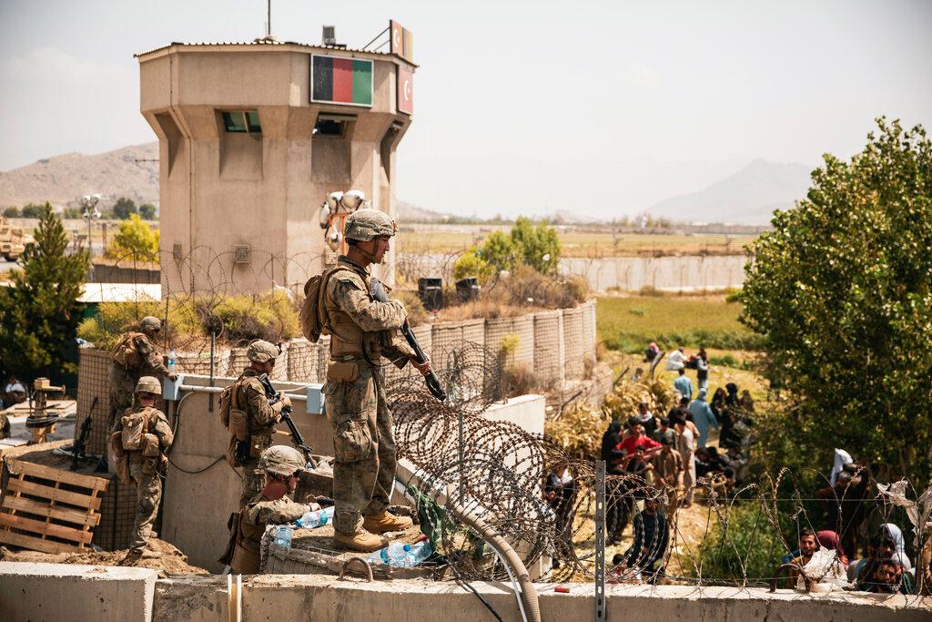 In this image provided by the US Marine Corps, marines assist with security at an evacuation control checkpoint during an evacuation at Hamid Karzai International Airport in Kabul, Afghanistan, Aug 20. Photo: AP