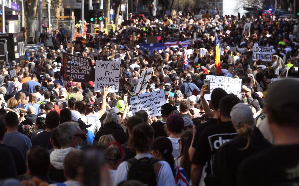 Protesters march through the streets during an anti-lockdown rally in Melbourne on Aug 21, as the city experiences its sixth lockdown while it battle an outbreak of the Delta variant of coronavirus. Photo: AFP