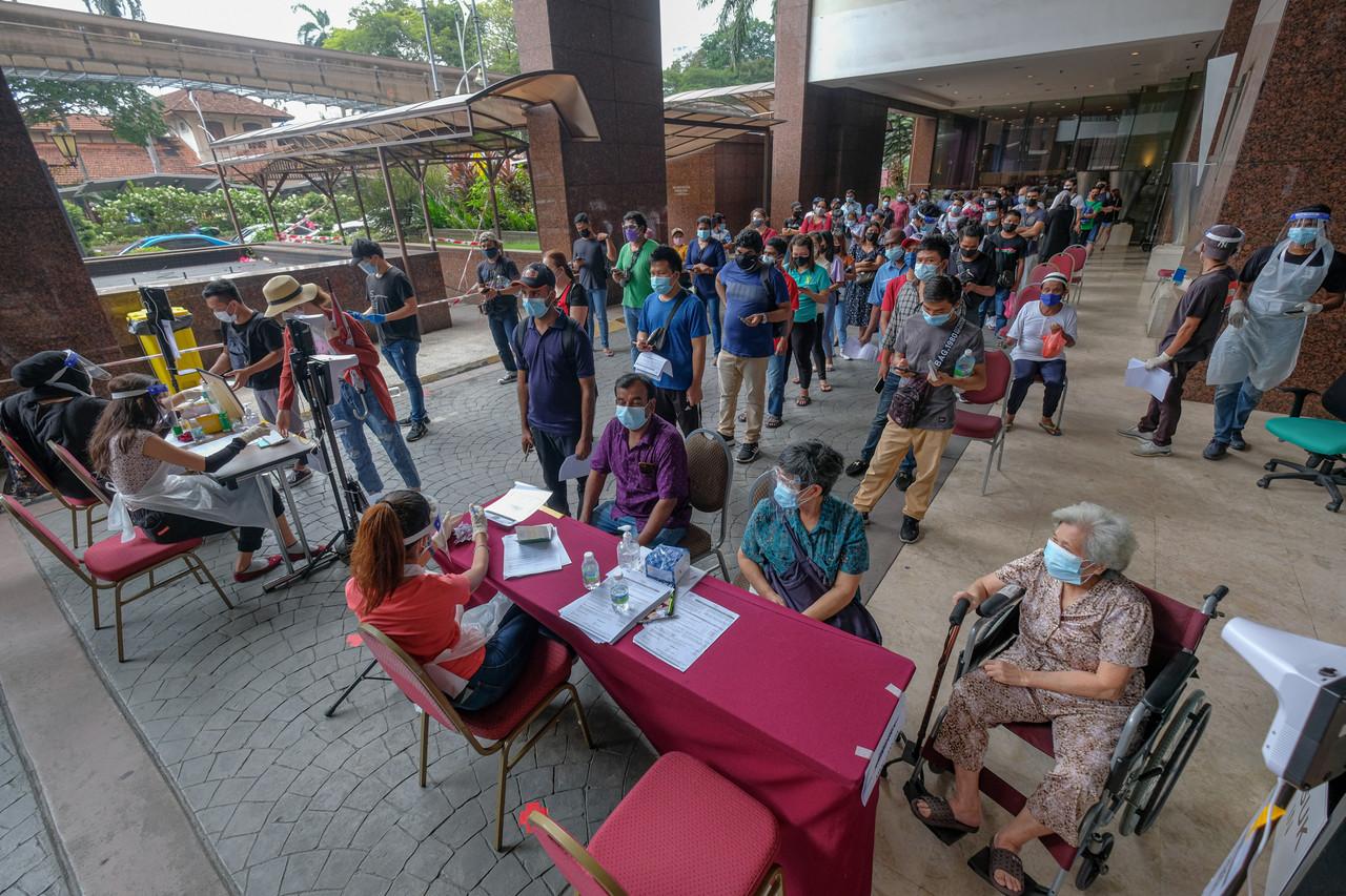 Walk-in recipients wait for their turn to receive a shot of Covid-19 vaccine at Rumah Prihatin at the Grand Seasons Hotel in Kuala Lumpur. Photo: Bernama