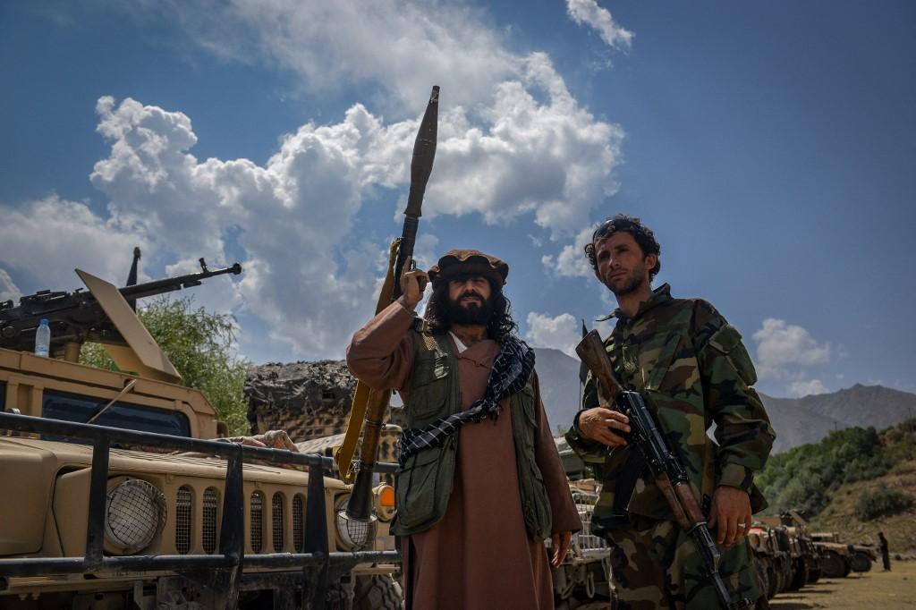Afghan armed men supporting the country's security forces against the Taliban stand with their weapons and humvee vehicles at Parakh area in Bazarak, Panjshir province on Aug 19. Photo: AFP