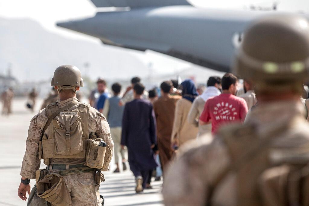 US Marines guide evacuees onto a US Air Force Boeing C-17 Globemaster III plane during an evacuation at Hamid Karzai International Airport in Kabul, Afghanistan, Aug 21. Photo: AP