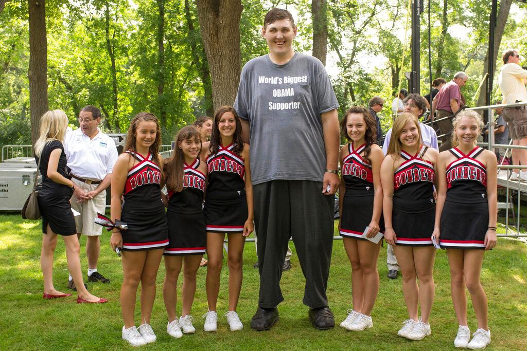 Igor Vovkovinskiy takes a photo with cheerleaders prior to a President Barack Obama town hall event in Cannon Falls, Minnesota, Aug 15, 2011. Photo: AP