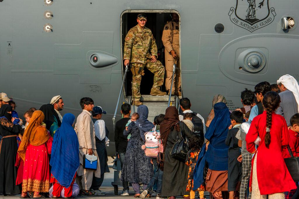 In this Aug 22 image provided by the US Air Force, service members prepare to board evacuees onto a C-17 Globemaster III at Al Udeid Air Base, Qatar. Photo: AP