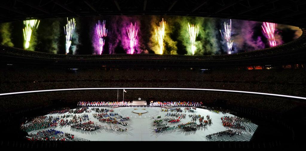 Athletes watch as fireworks explode during the opening ceremony for the 2020 Paralympics at the National Stadium in Tokyo, Aug 24. Photo: AP