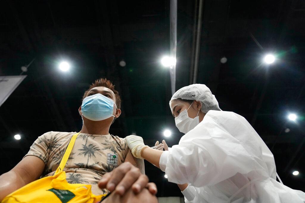A health worker administers a dose of the AstraZeneca Covid-19 vaccine to a man in Bangkok, Thailand, Aug 20. Photo: AP