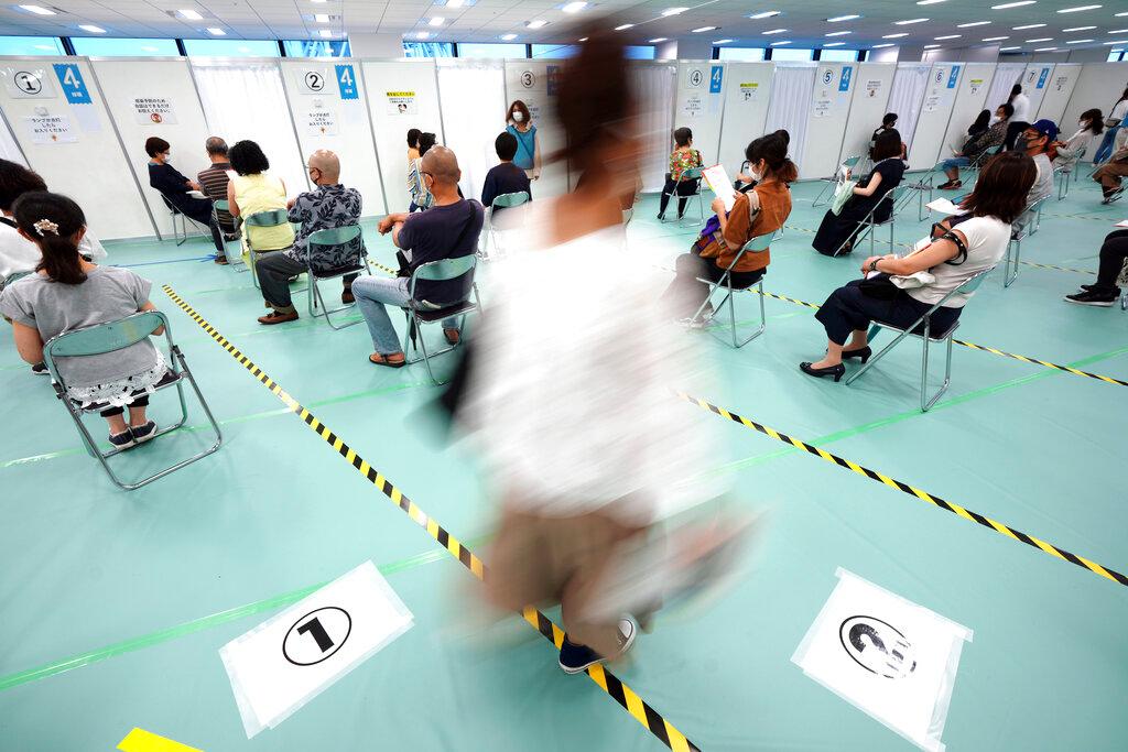 In this June 30 file photo, residents wait for the Moderna Covid-19 vaccine at a vaccination centre in the Sumida ward of Tokyo. Photo: AP