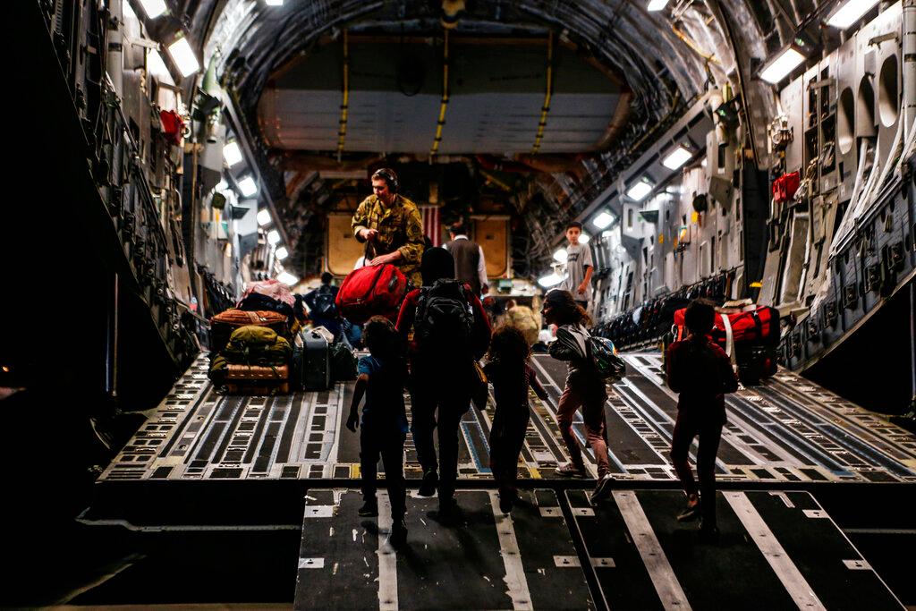A woman and her children board a Boeing C-17 Globemaster III at Hamid Karzai International Airport, Kabul, Afghanistan, Aug 23 in this image provided by the US Marine Corps. Photo: AP