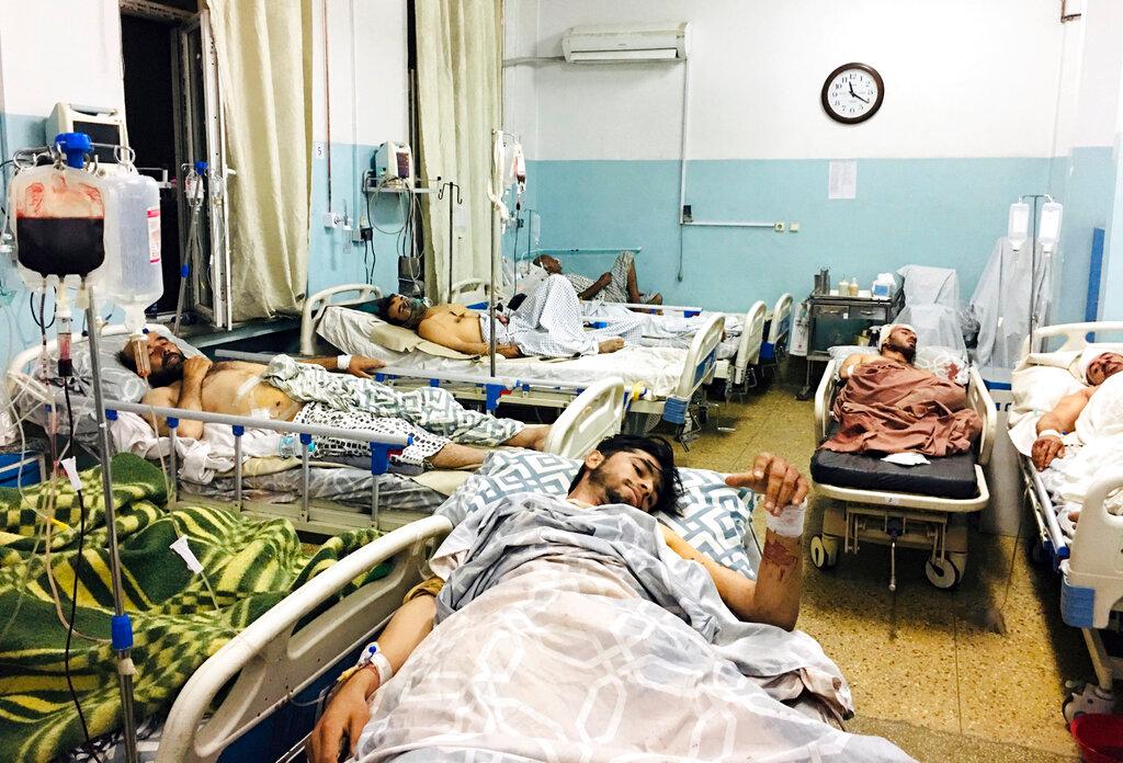 Afghans lie on beds at a hospital after they were wounded in the deadly attacks outside the airport in Kabul, Afghanistan, Aug 26. Photo: AP